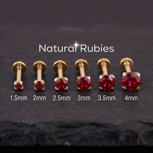 A collection of gold-colored metal piercings with red gemstones, ranging from 1.5mm to 4mm in size, arranged in a row.