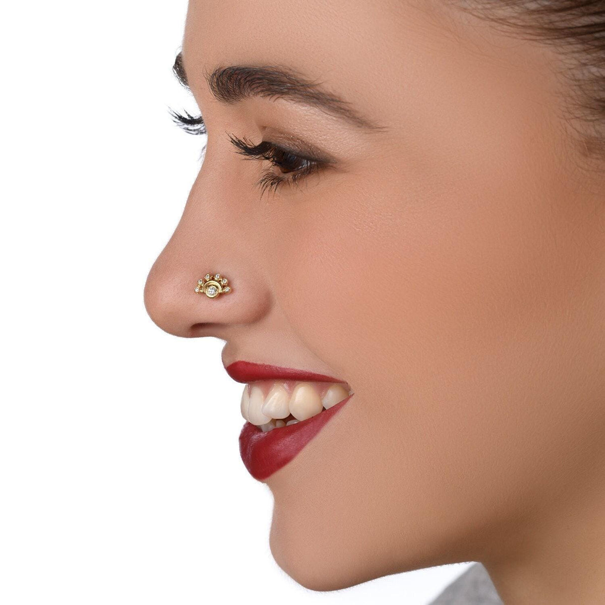 A close-up of a woman's face, focusing on her nose and lips, with a bright smile.
