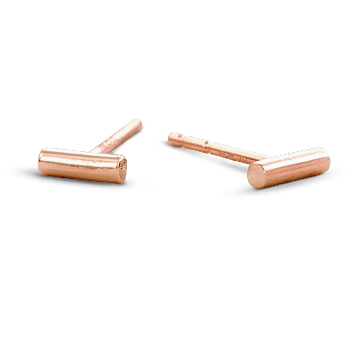 a pair of small, round, metallic earrings made of copper.
