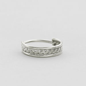 A silver ring with a decorative band design.