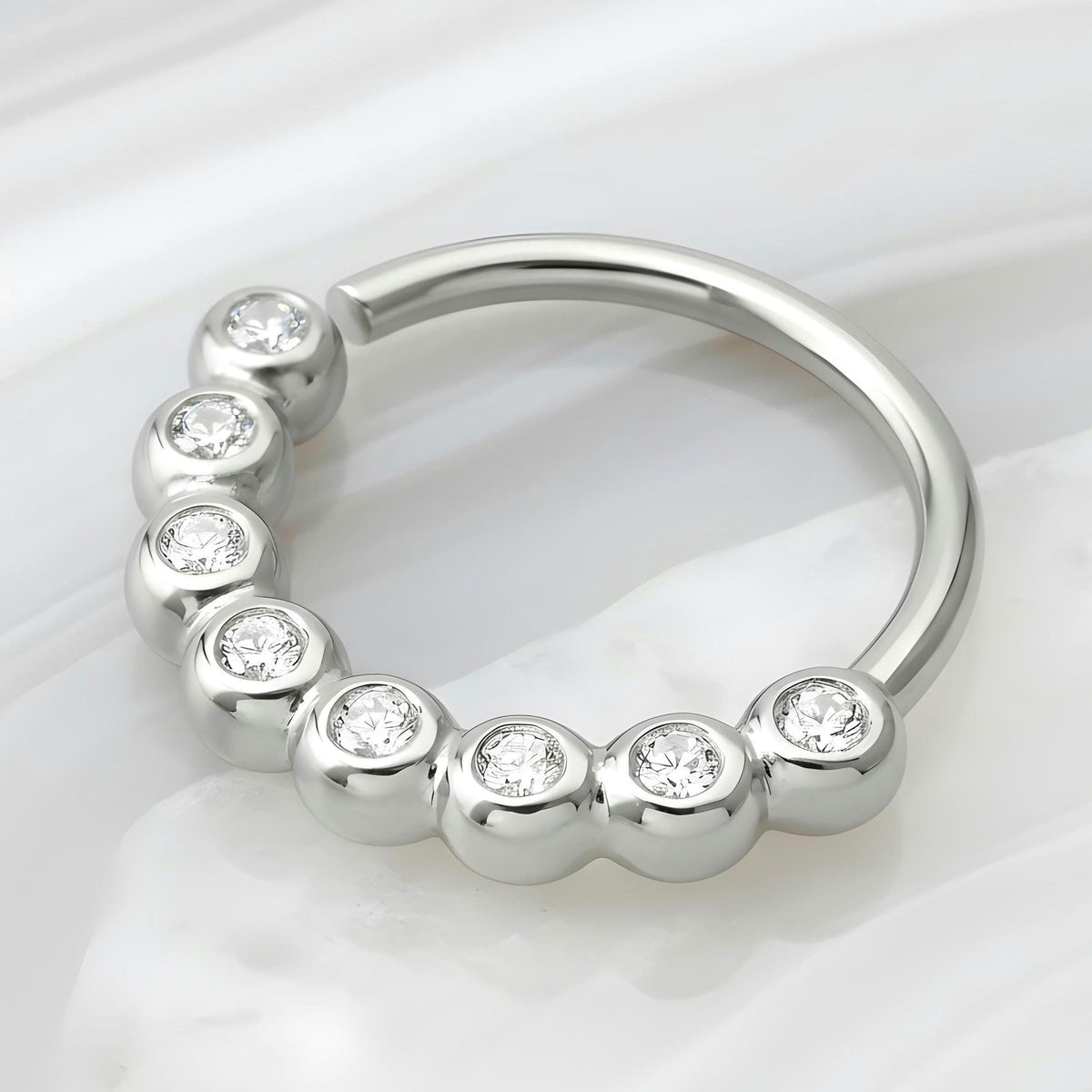 A unique nose ring in solid 14k white gold and neturl diamonds
