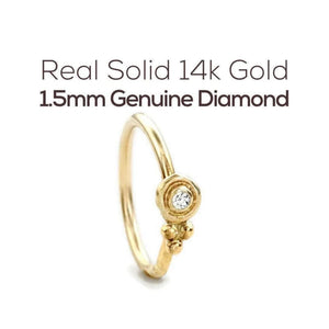 a gold ring with a genuine diamond set in the center.