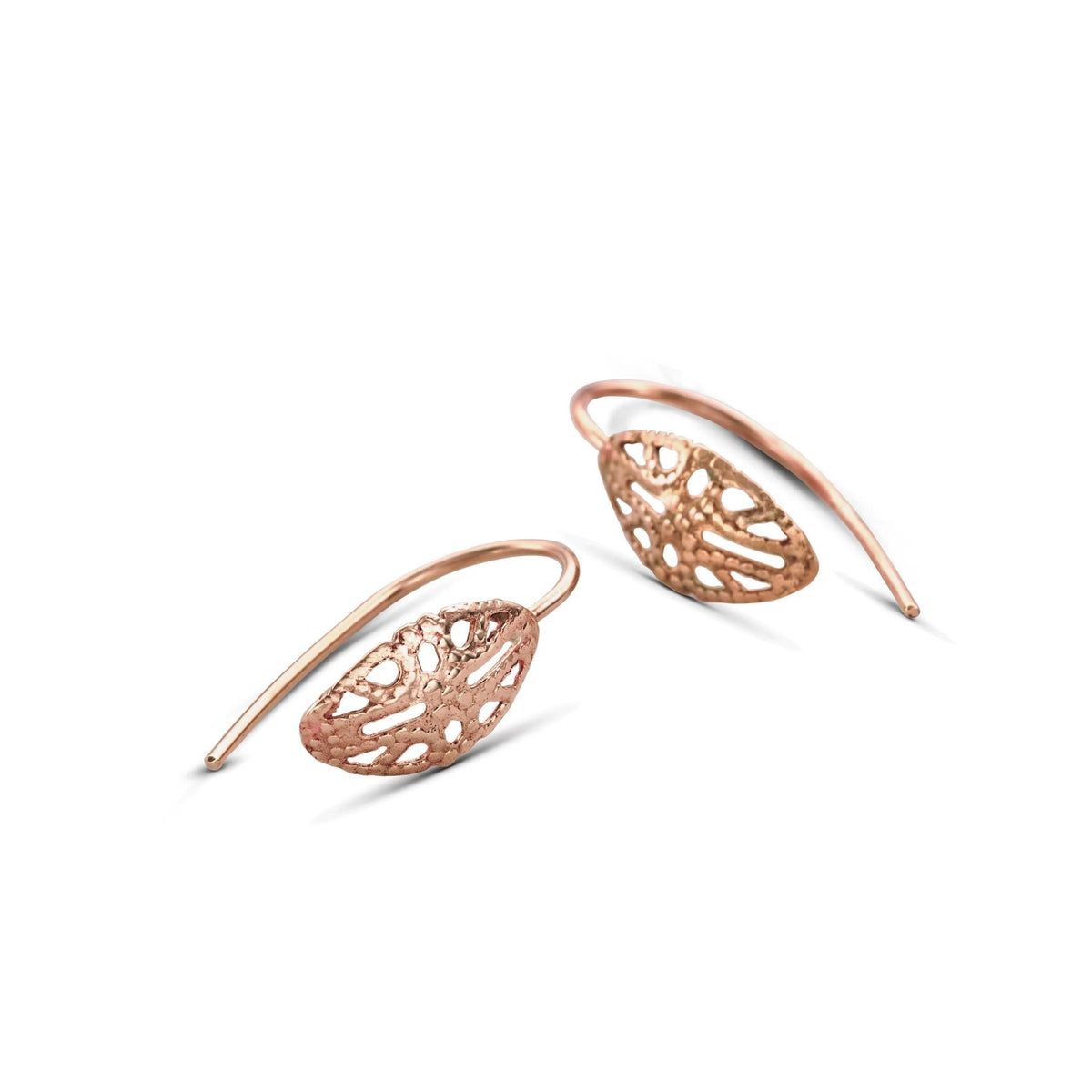 a pair of delicate, intricately designed earrings with a rose gold color. The earrings have a floral pattern and are positioned on a white background.