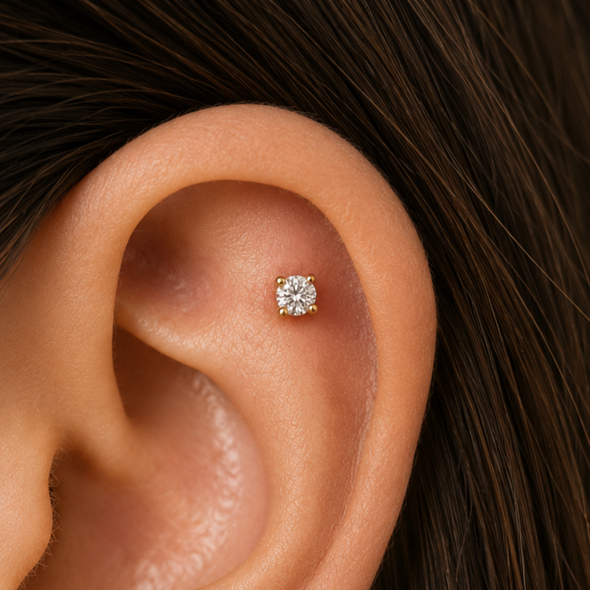 A small diamond earring is visible in the ear.