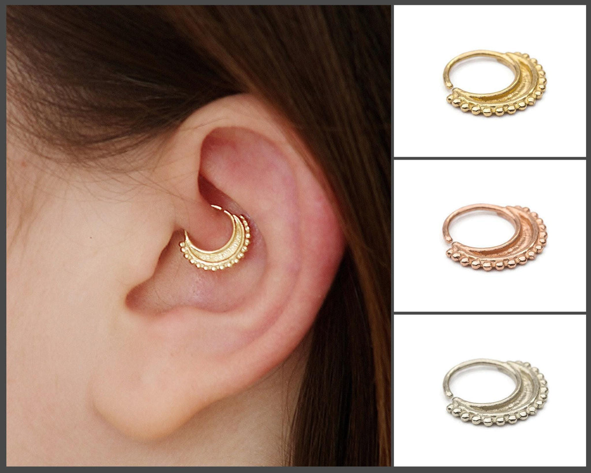 A close-up of a person's ear with a gold-colored earring, and four images of different types of earrings in various colors.
