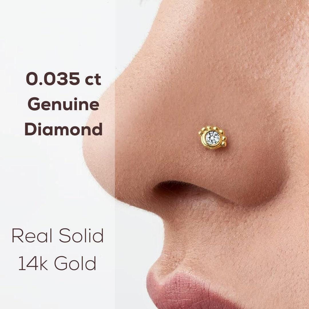 Gold Diamond Nose Stud: a close-up of a person's nose with a small, genuine diamond nose ring.