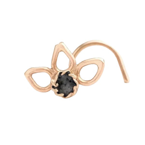 A gold-colored nose ring with a small black gemstone in the center.