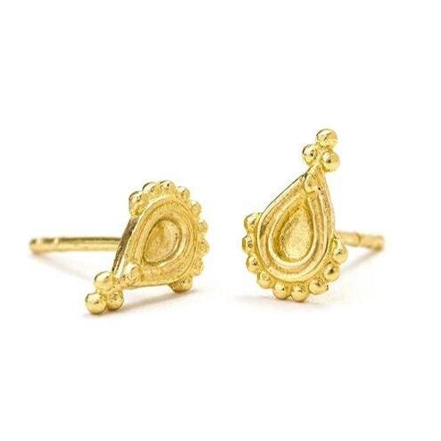 a pair of gold earrings with intricate designs, including a teardrop-shaped pendant and small round decorations