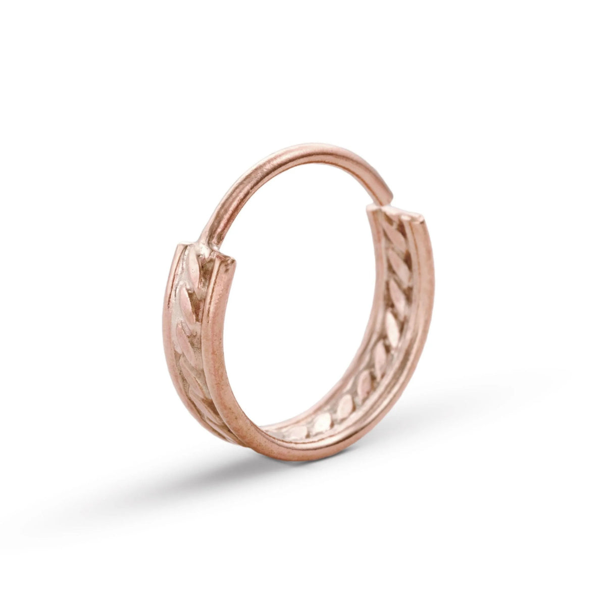 A gold-colored ring with a twisted, braided design.
