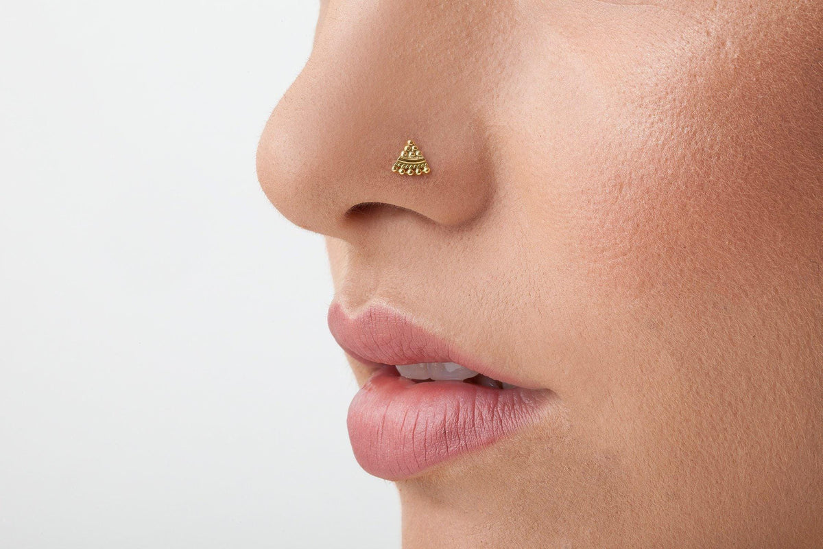 Handmade Tribal Nose Stud: A close-up of a person's face, focusing on their nose and lips.
