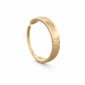 A gold ring with a textured, embossed design.