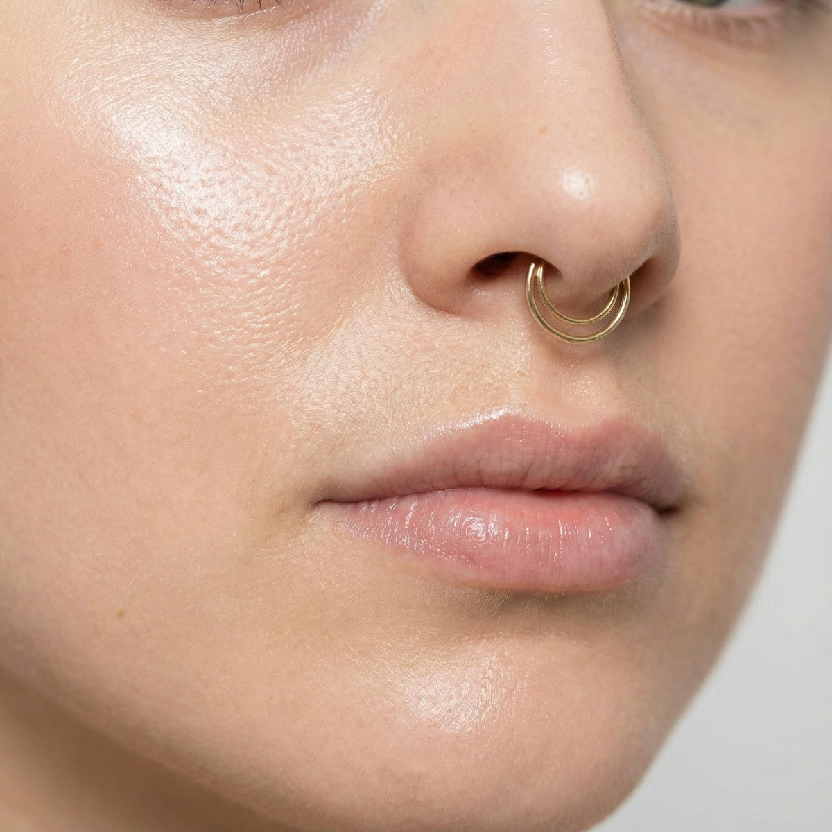 Moon Septum Ring: A close-up of a person's face, focusing on their nose and mouth area.
