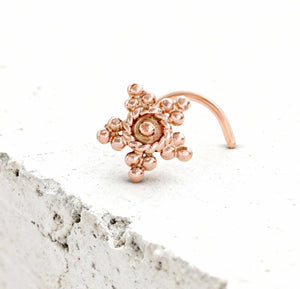 Tribal Star Nose Stud: A copper-colored metal nose ring with a star-shaped design and small beads or stones.