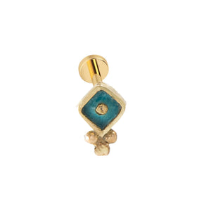A gold-colored earring with a blue gemstone in the center, hanging from a gold-colored post.