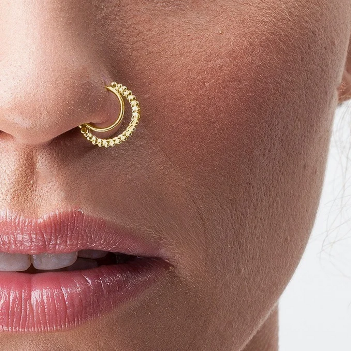 A close-up of a person's face, focusing on their nose and lips.
