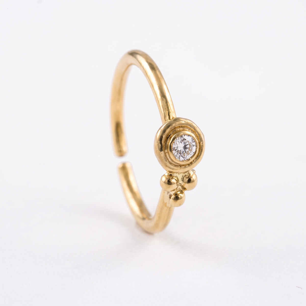 a close up of a gold ring with a diamond