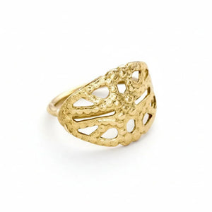 A gold ring with an intricate, leaf-like design.