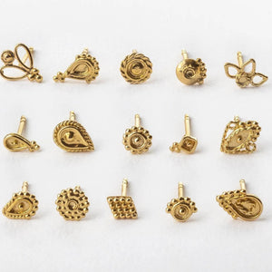 Solid 14k Gold Stud Earrings: a collection of 12 gold-colored earrings arranged in a grid pattern on a white background