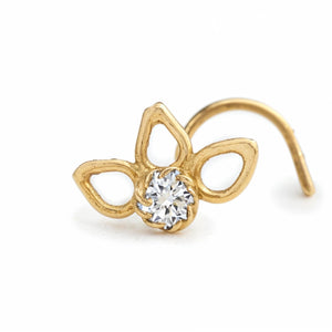A gold-colored nose ring with a clear gemstone in the center.