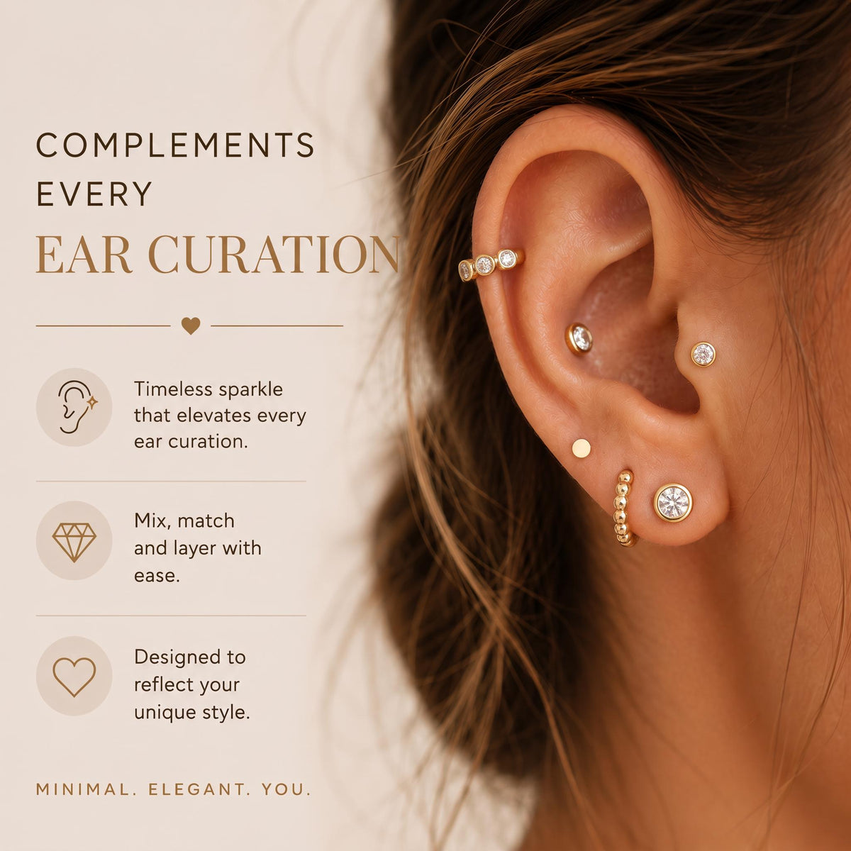 a close-up of a person's ear adorned with multiple earrings, including a diamond-encrusted earring and a beaded earring.