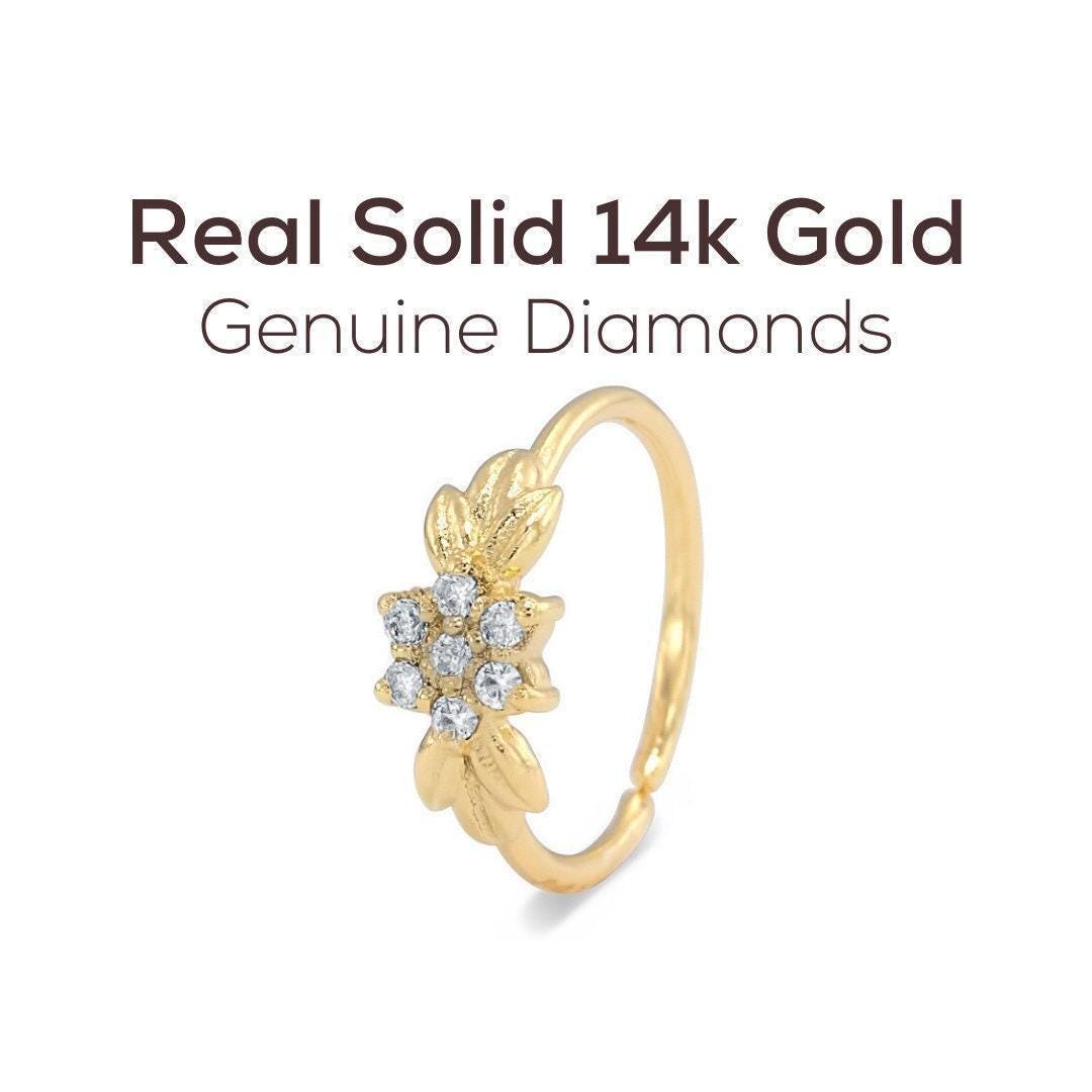 a gold ring with a flower-shaped gemstone set in the center.