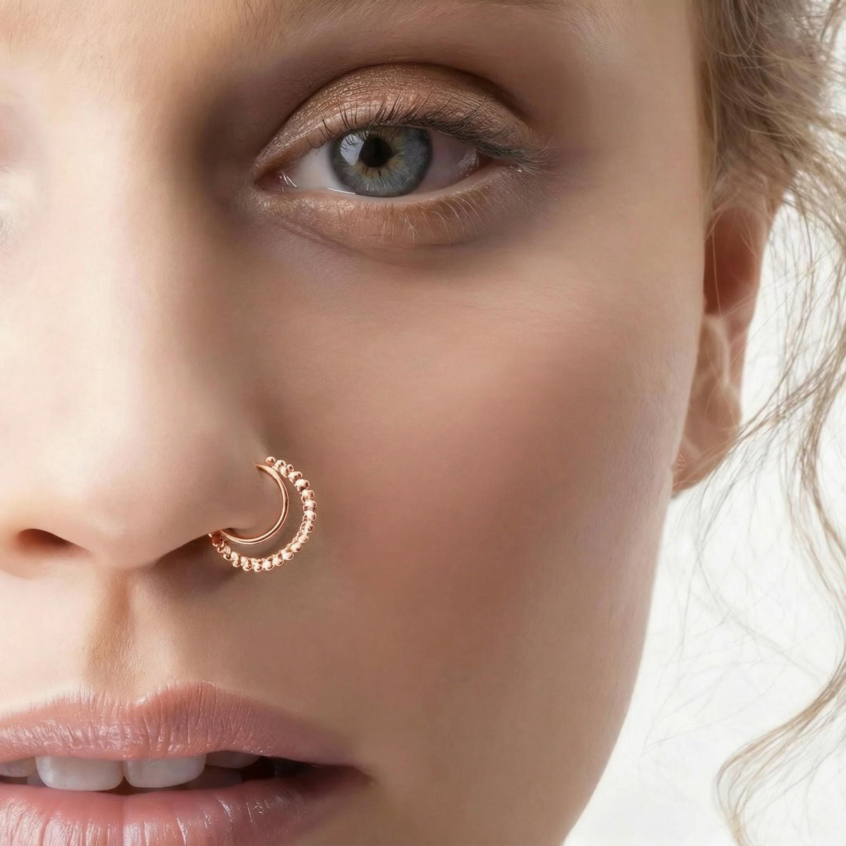 A close-up of a woman's face, focusing on her nose and eye.