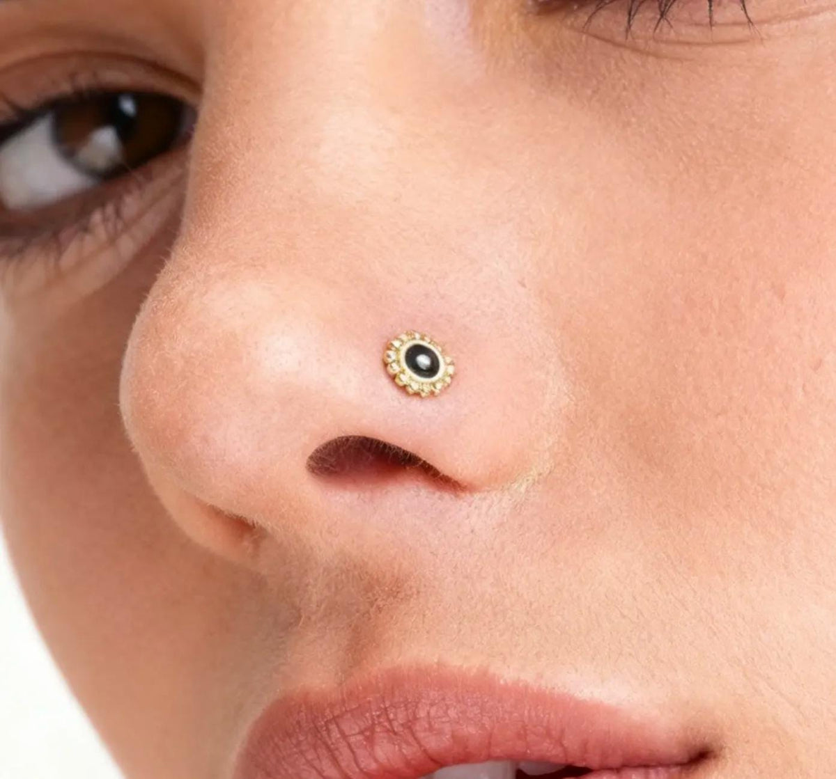 A close-up of a woman's face, focusing on her nose and lips.