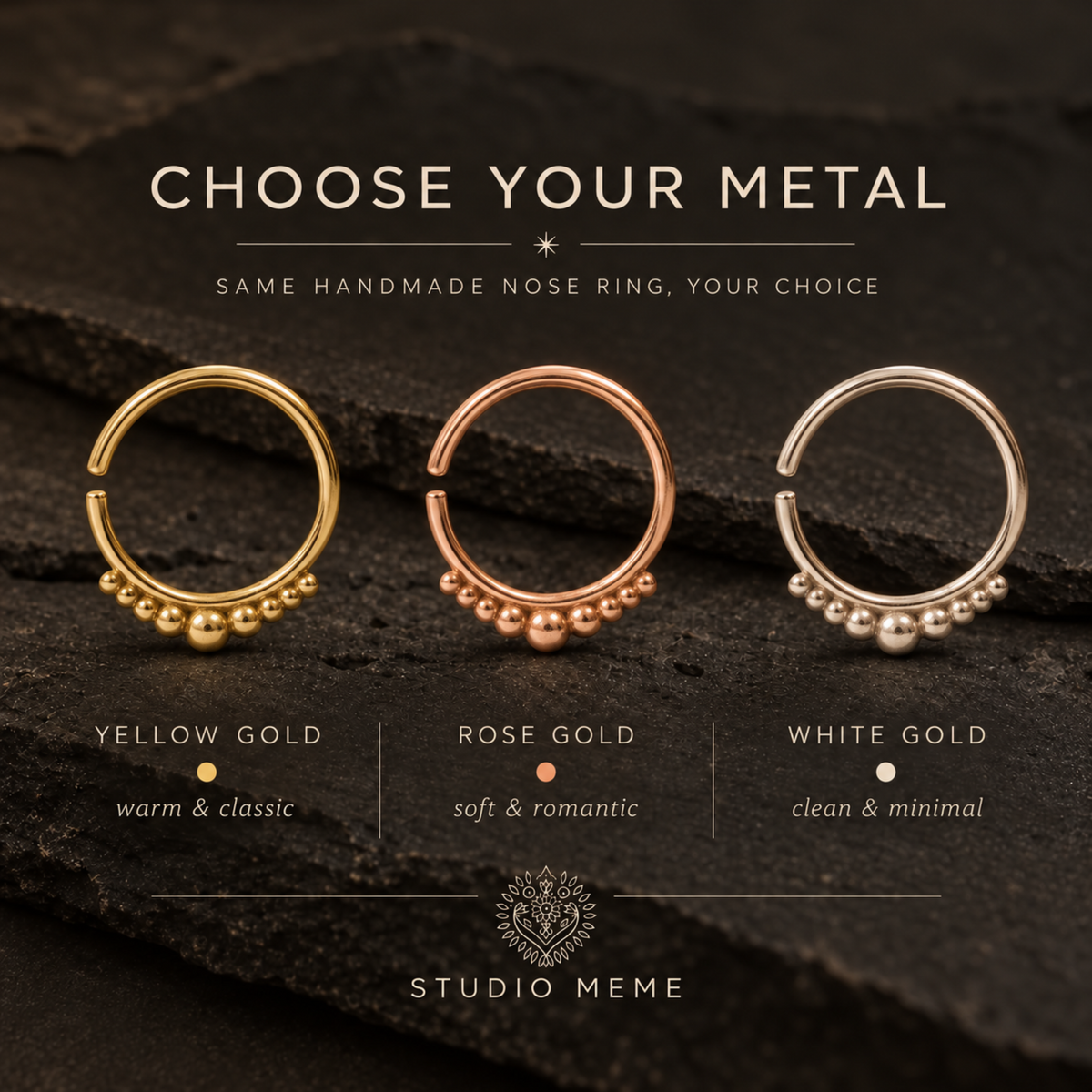 three different nose rings, each with a unique color and style, arranged on a dark surface.