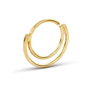 A gold-colored ring with a unique, twisted design.