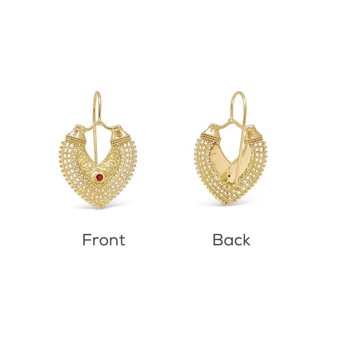 two gold earrings with intricate designs, one facing forward and the other facing backward.