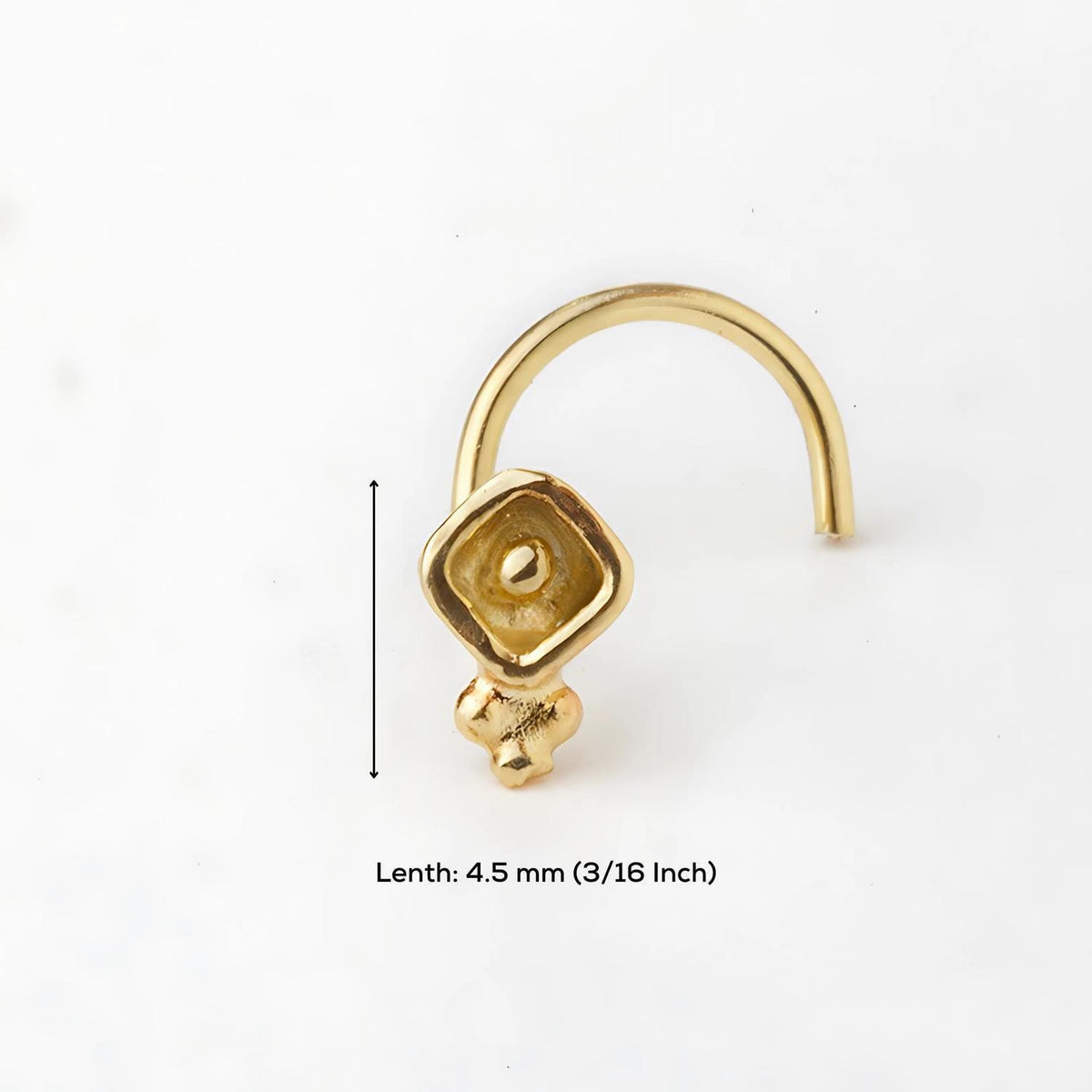 A gold-colored nose ring with a small square-shaped charm on the front, and a measurement scale indicating the length of the nose ring is 4.5 millimeters (3/16 inch).