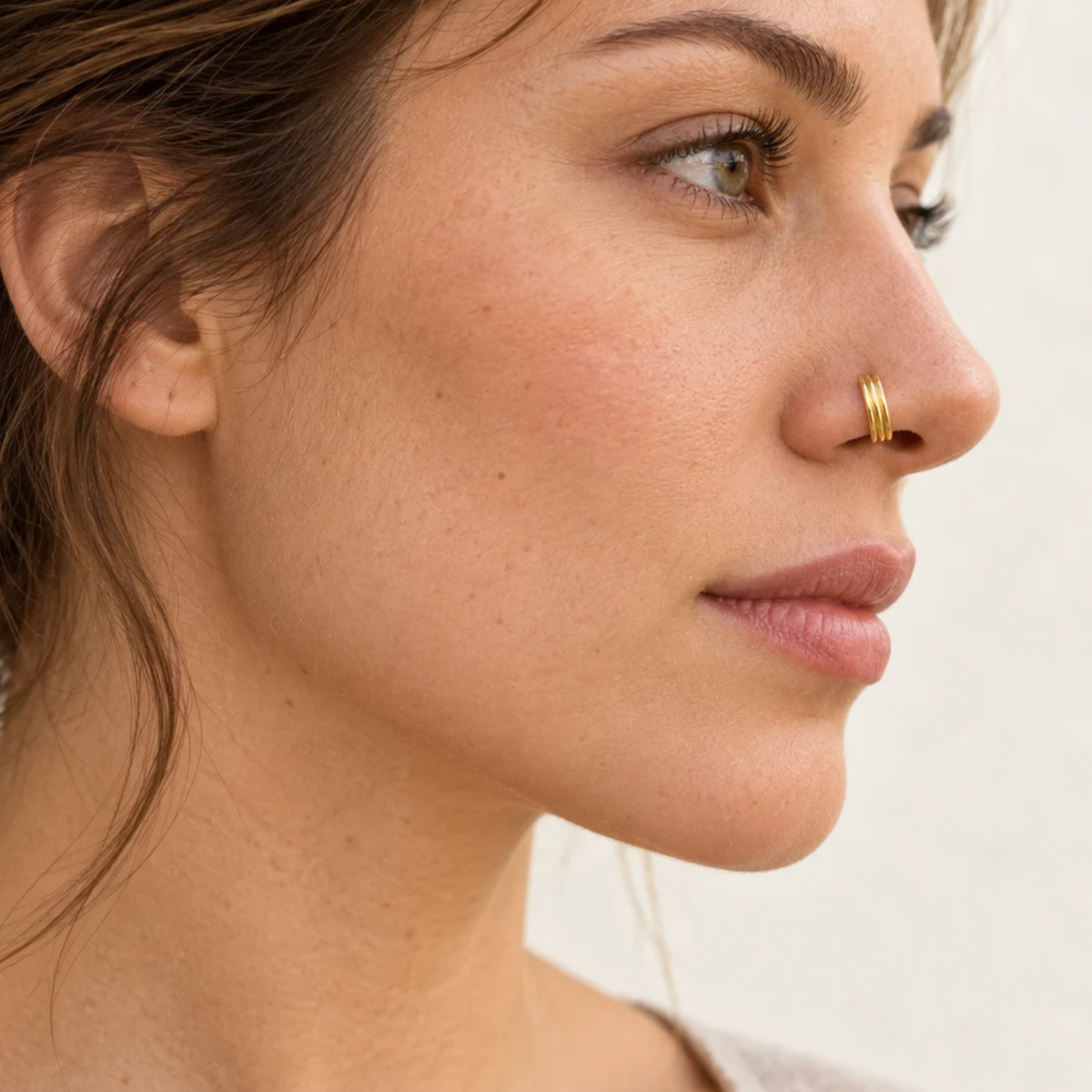 A close-up of a woman's face, focusing on her nose and upper lip.