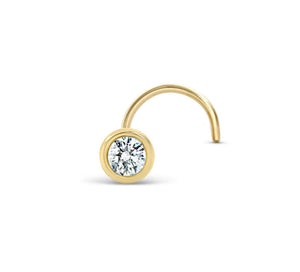 A gold-colored nose stud with a clear gemstone set in the center.