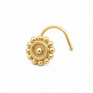 A gold-colored nose ring with a decorative floral design.