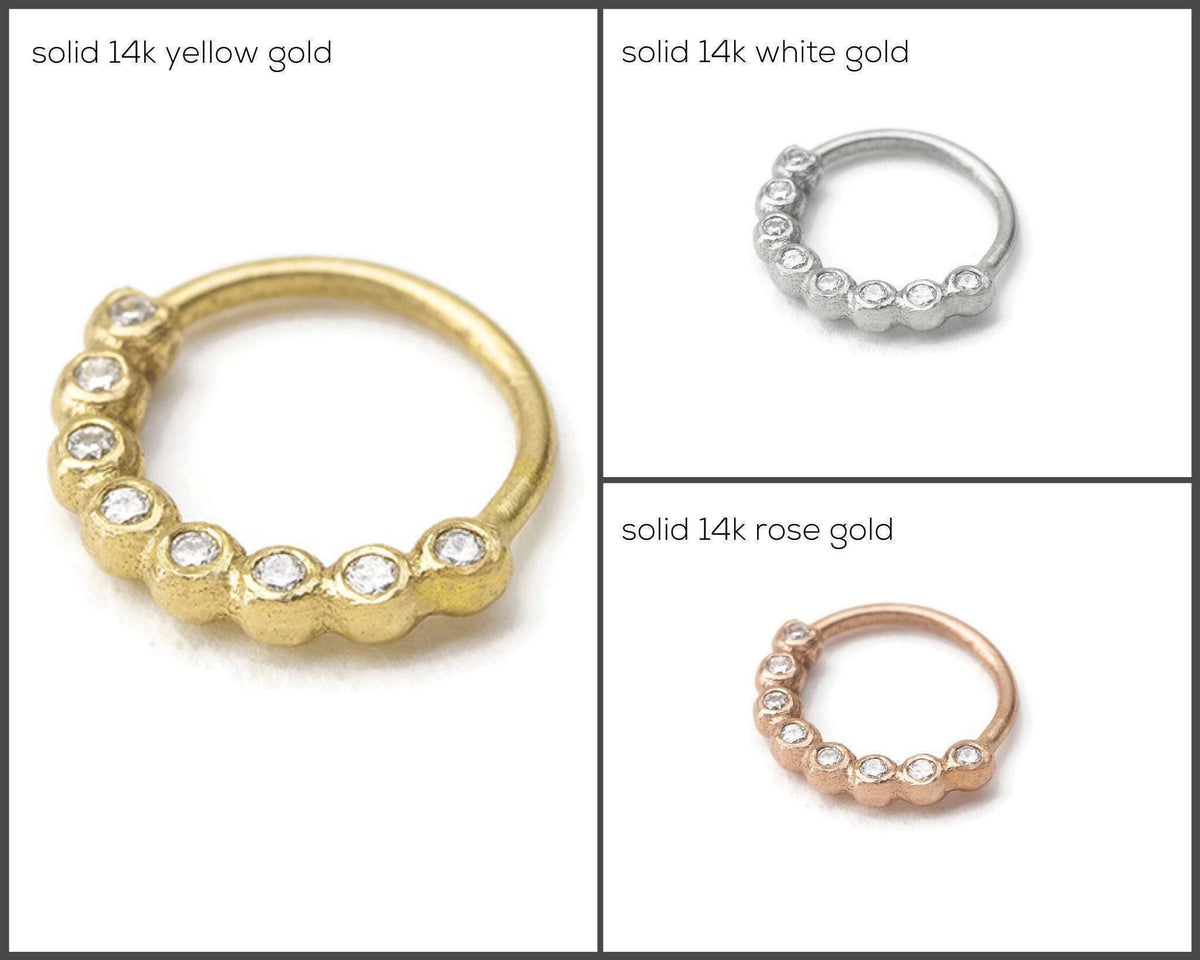 three different types of nose rings, each with a unique design and color: solid 14k yellow gold, solid 14k white gold, and solid 14k rose gold.